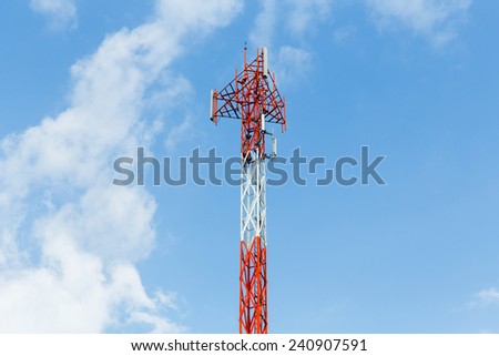 Close up red and white color antenna repeater tower on blue sky