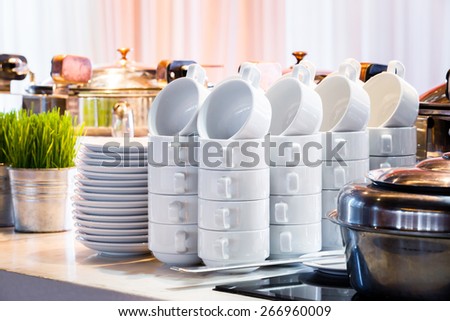 Close up stacks of white color ceramic coffee cup and dish ready for use in party room, catering service