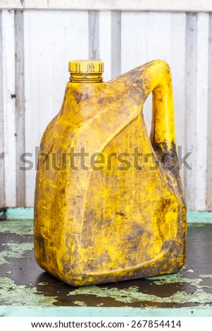 Close up old and dirty car engine oil gallon, plastic container, automotive maintenance service