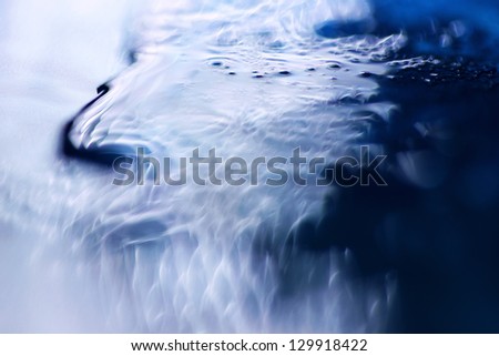 Bizarre waves and swirls. macro shot of blue liquid soap
