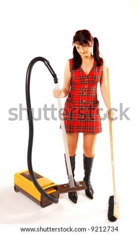Woman with a vacuum cleaner and broom