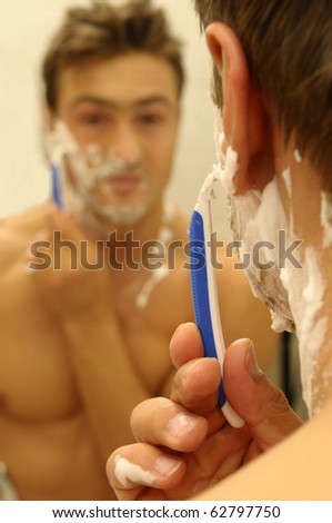 A shaving man in the mirror