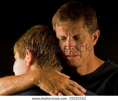 Hugging son, father cries (death, divorce, family fight, or similar)