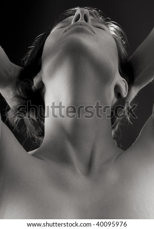 sensual close-up portrait of woman, head back, hands in her hair
