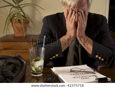 Businessman with bad sales report, drinking alone, showing frustration and anxiety