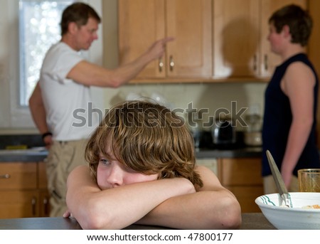 Young son nearly crying as father yells at older son