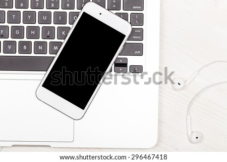 Mobile phone and laptop on the table