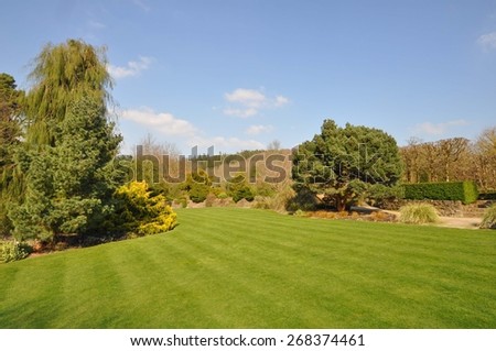 Perfect lawn within an established English country garden, boarders and mature trees and shrubs add to the flow of the garden.
