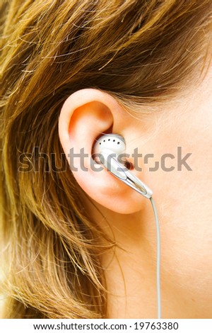 Female ear with headphones