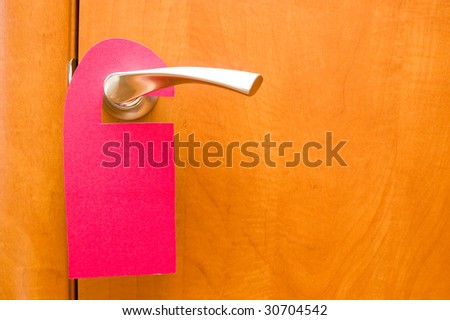 Blank do-not-disturb sign on a door handle.