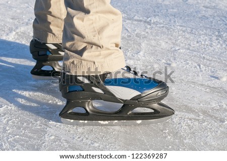 Men`s legs in ice skates