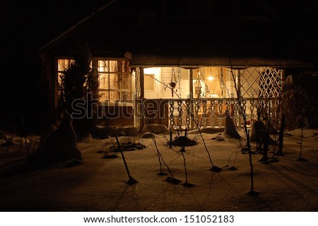 Wooden house in dark winter forest