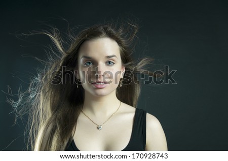 Portrait of young girl with fluttering hair
