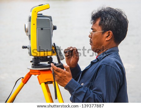Surveyor worker make data collection with total station surveying, theodolite at construction site.