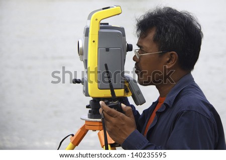 Surveyor worker make data collection with total station surveying, theodolite at construction site.