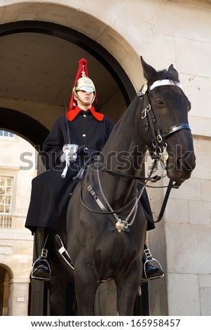 LONDON, ENGLAND - NOVEMBER 15: Member of the Royal Horse Guards stands outside the entrance to the listed Horse Guards in Whitehall on November 15, 2013 in London, England.