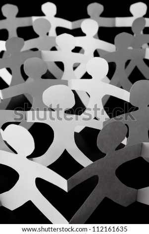 paper chain people on black background