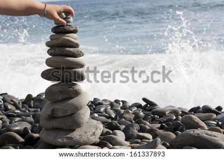stack of pebbles in balance with the sea background