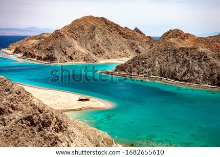 Panoramic view of Fjord Bay in Taba, South Sinai, Egypt. Turquoise water and rocky mountaintains around.
