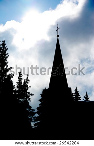 View of the tower of a church with backlighting effeect.