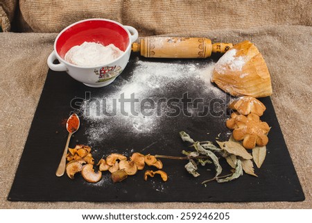 flour on the black board. Rustic kitchen or bakery