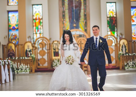 Bride and groom leaving the church after a wedding ceremony