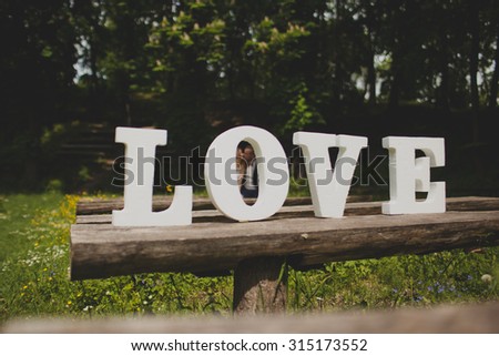 Wedding couple outdoors with word love