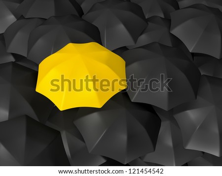 Yellow open umbrella standing out from the crowd, over many dark ones, group of black umbrellas.