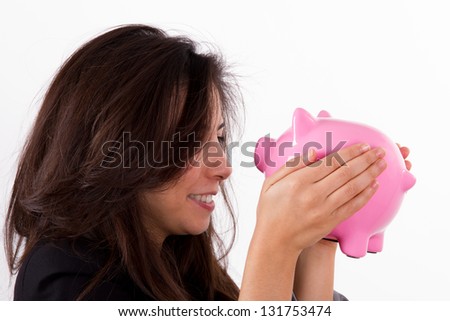 Young beautiful business woman and pink piggy bank, face to face, isolated on white background.