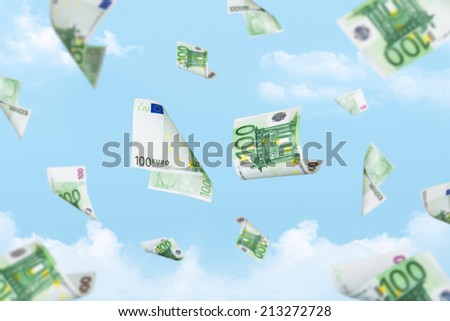 Euro banknotes falling down on cloudy sky background.