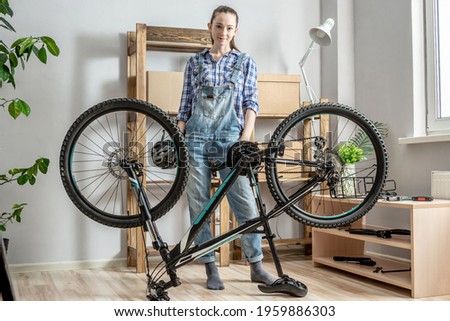 Similar – Image, Stock Photo Woman fixing bike in workshop