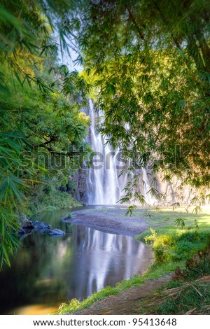 Scenic view of Niagara waterfall in picturesque forest with river in foreground, Reunion Island.