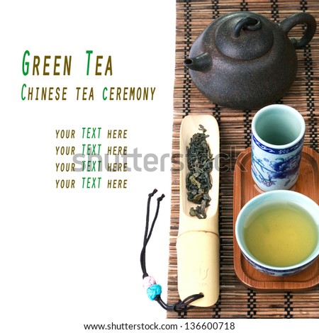 Traditional chinese tea ceremony accessories (tea pot and cups) on bamboo mat  with sample text
