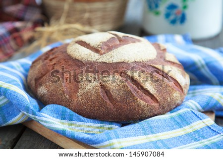 Round Loaf of Home made Bread made from rye, whole wheat flour and sourdough in rustic style, selective focus