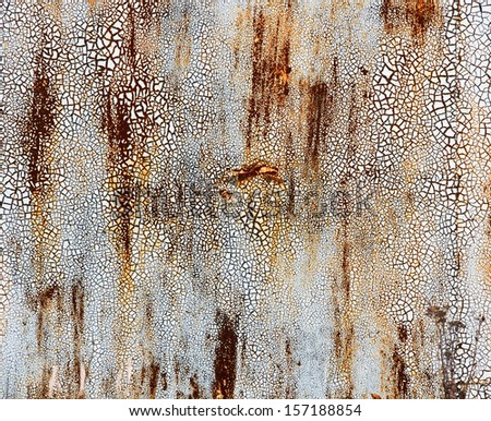 Grunge background painted metal surface covered with small rust and cracked paint