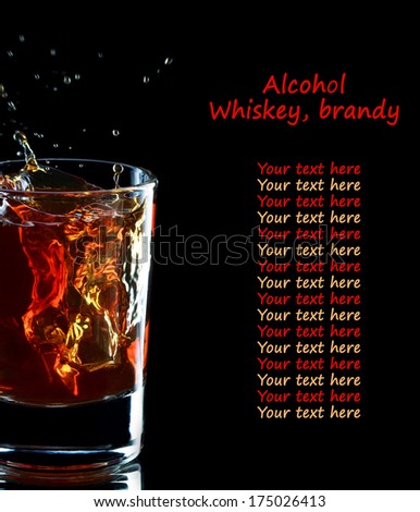 Glass of whiskey with splash on dark background, selective focus on the glass, place for text