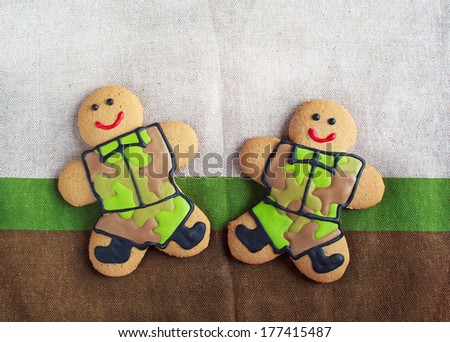 Homemade Gingerbread men in protective khaki uniforms on Defender of the Fatherland Day