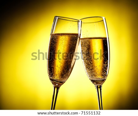 flutes of champagne over yellow background