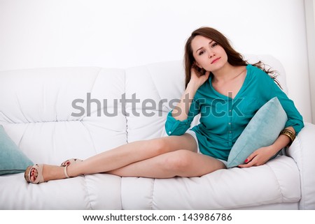 Pretty woman relaxing on couch with feet up at home