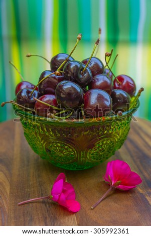 Cherries on wooden table with water drops background.