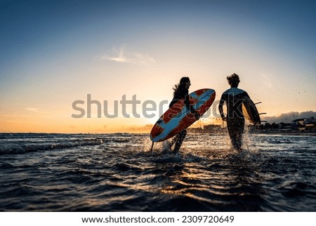 Similar – Image, Stock Photo Female surfer walking at the beach with surfboard