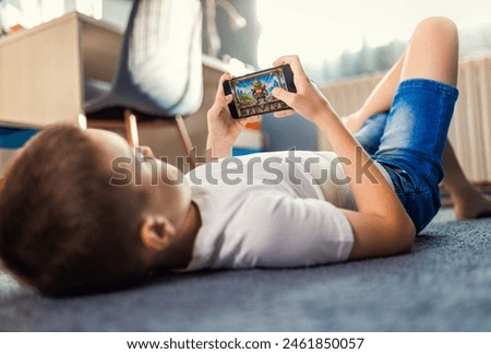 Similar – Foto Bild Junge spielt auf dem Handy