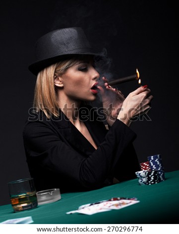 Beautiful young woman smokes a cigar during a poker game, Dark color Intensity.