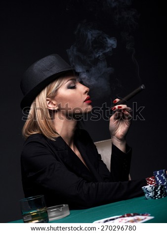 Beautiful young woman smokes a cigar during a poker game, Dark color Intensity.