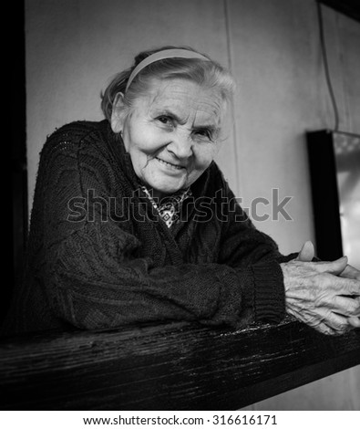 Senior lady on porch, Black and white