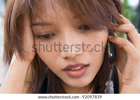 Portrait sad woman with cellular telephone