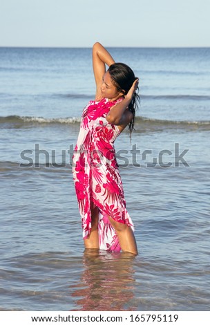 woman in wet clothes on the sea shore
