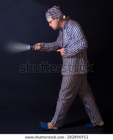 Man In Pajamas Walking Around With A Gun. The Man In The Striped ...