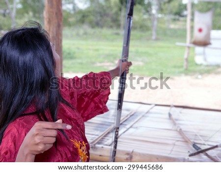 young Asian woman practicing archery