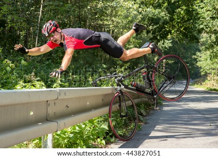 Cyclist falls off the bike into bushes. Accident on the road. Biker fall from the bike into the grass. Bicycle accident when falling through road barriers. Accident man in sports.